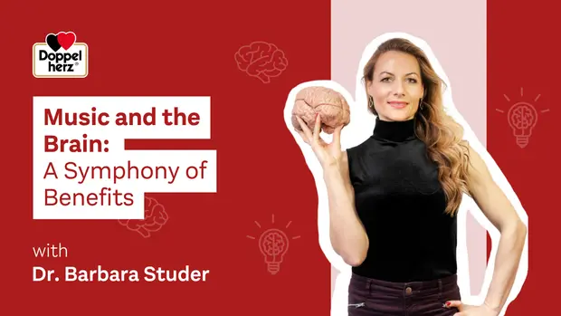 Na rdeči ozadju se nahaja ženska, oblečena v črno, ki drži model človeškega možgana. Na levi strani so napisani naslov "Music and the Brain: A Symphony of Benefits" in ime "Dr. Barbara Studer". V ozadju so tudi simboli možganov in žarnic.